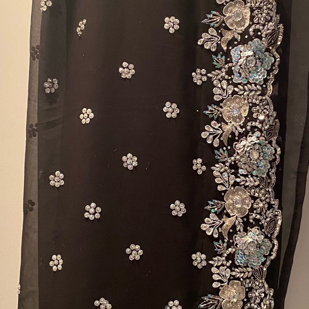 Black pure georgette party sari with lots of hand done embroidery. Final sale